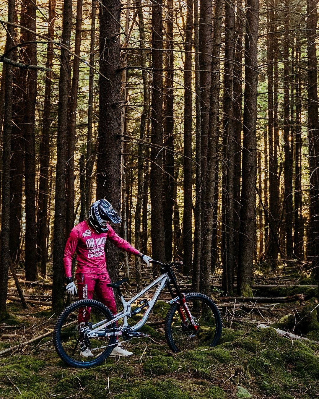Rider in the woods wearing DHaRCO clothing